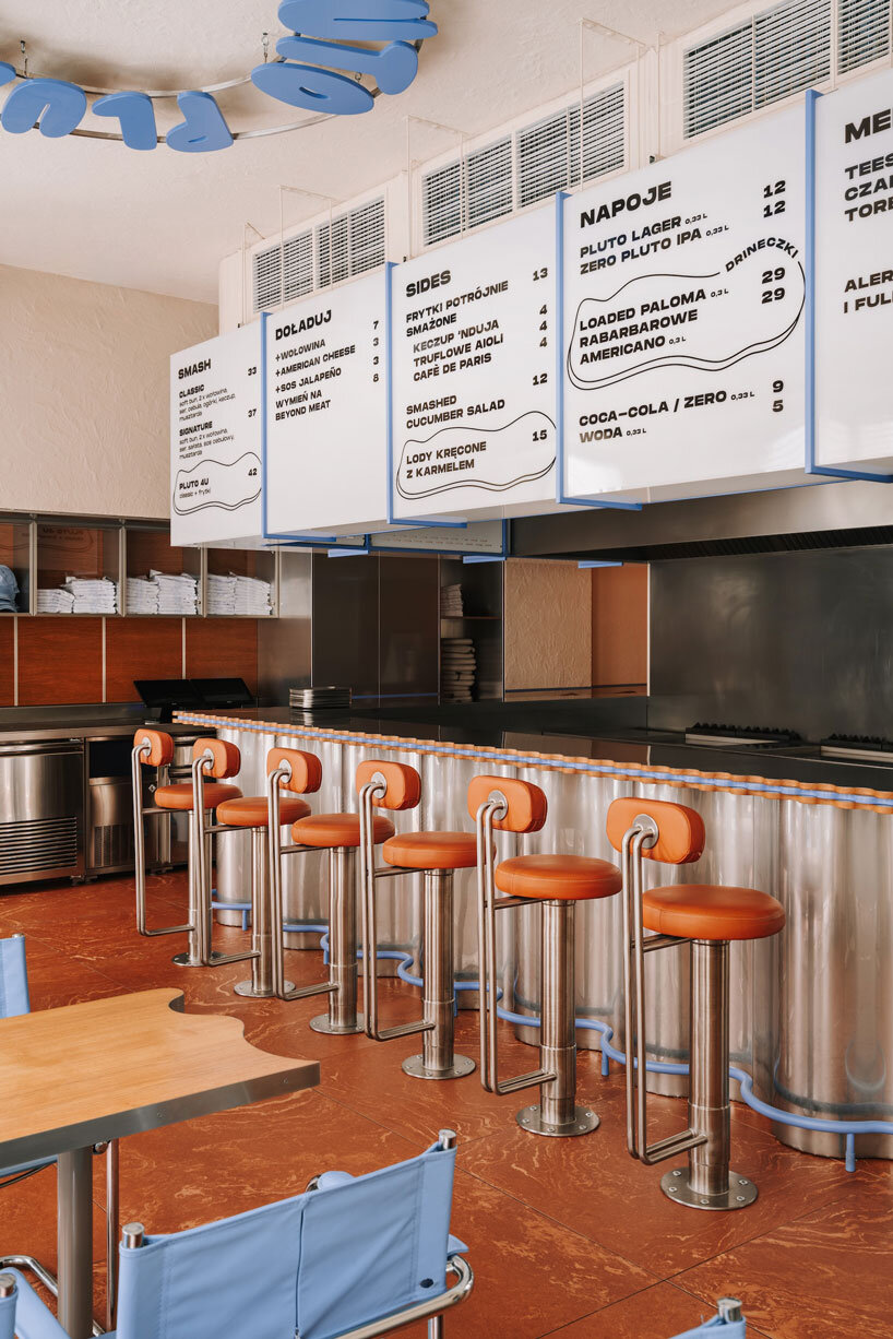 caramel tones and fluid undulating lines form melting interior of pluto burger bar in poland