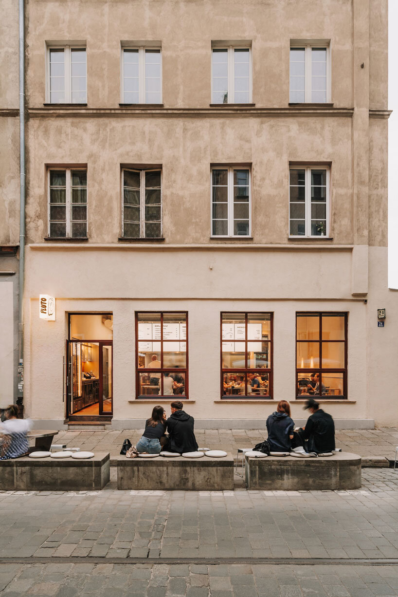 caramel tones and fluid undulating lines form melting interior of pluto burger bar in poland