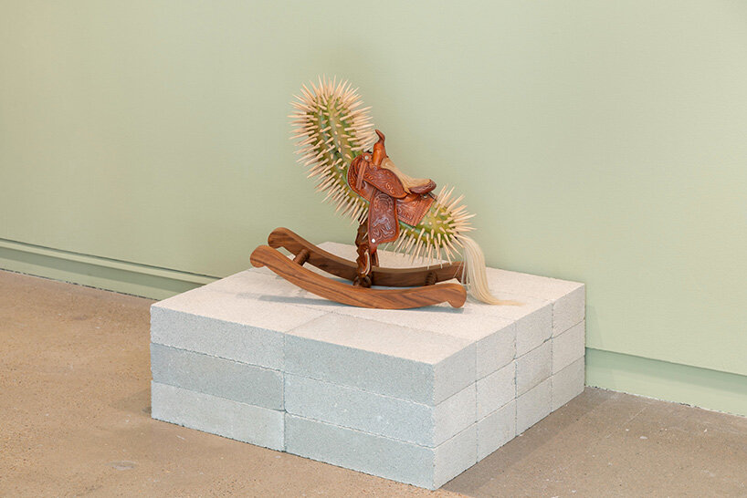 raul de lara carves surreal wooden sculptures to question who gets to belong