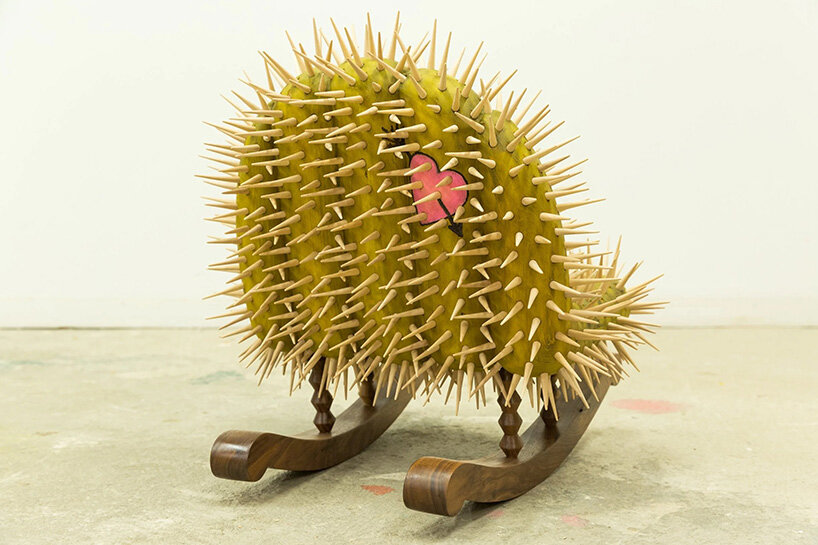 raul de lara carves surreal wooden sculptures to question who gets to belong