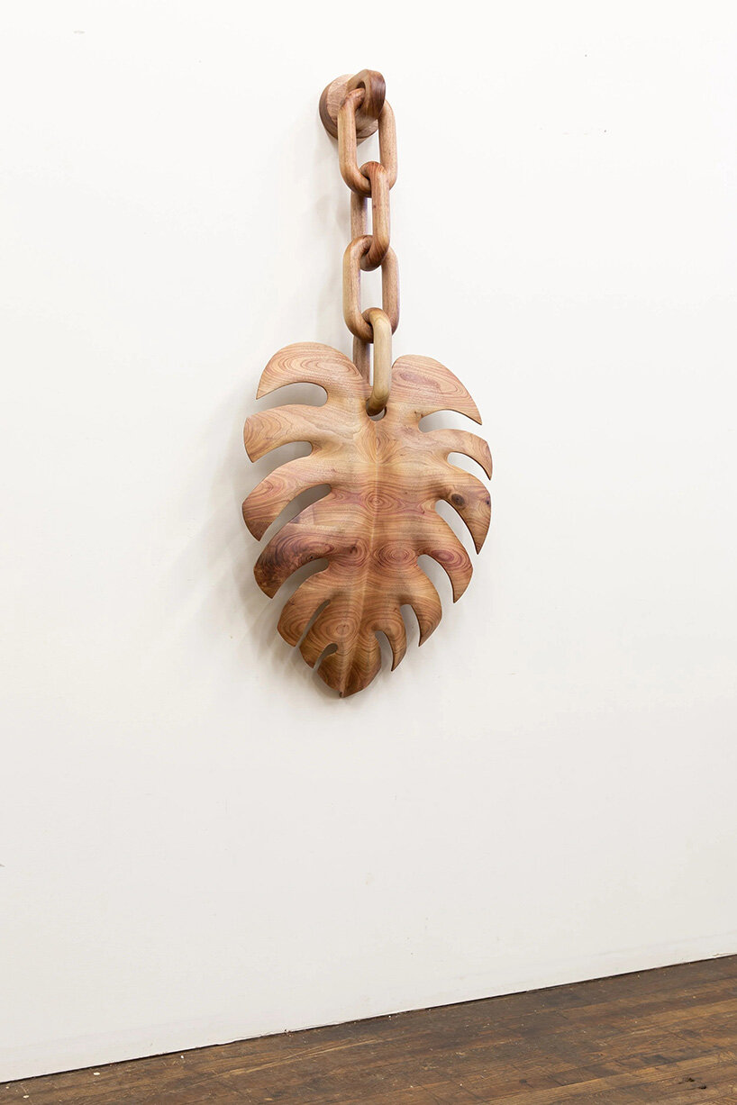 raul de lara carves surreal wooden sculptures to question who gets to belong