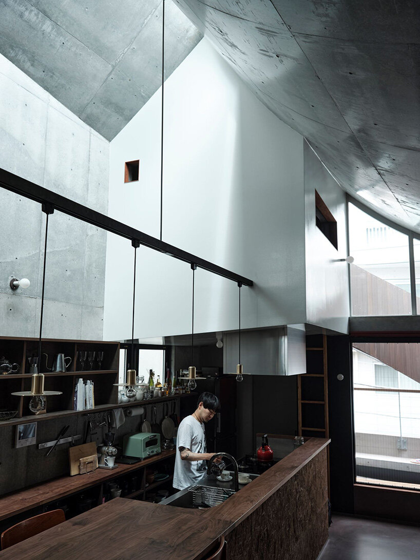 semi-cylindrical roof brings daylight into AOIM's three-story residence in tokyo