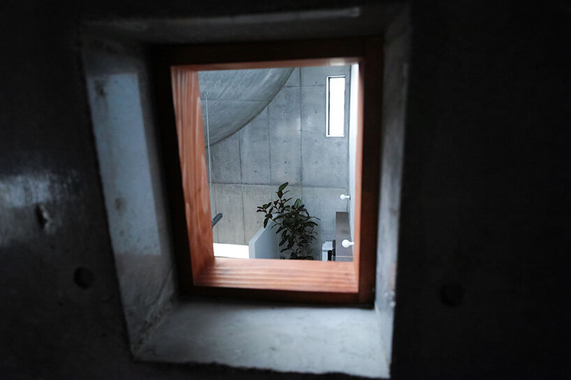 semi-cylindrical roof brings daylight into AOIM's three-story residence in tokyo