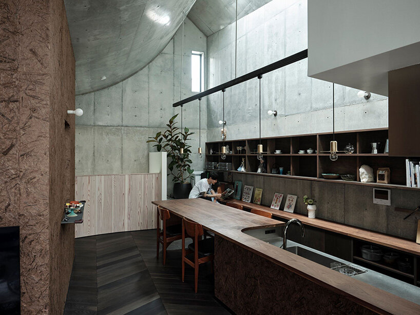 semi-cylindrical roof brings daylight into AOIM's three-story residence in tokyo