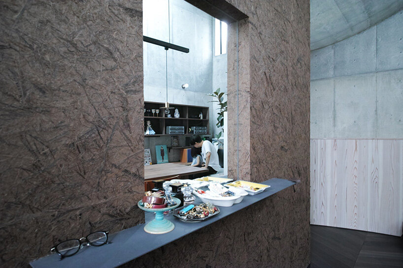 semi-cylindrical roof brings daylight into AOIM's three-story residence in tokyo