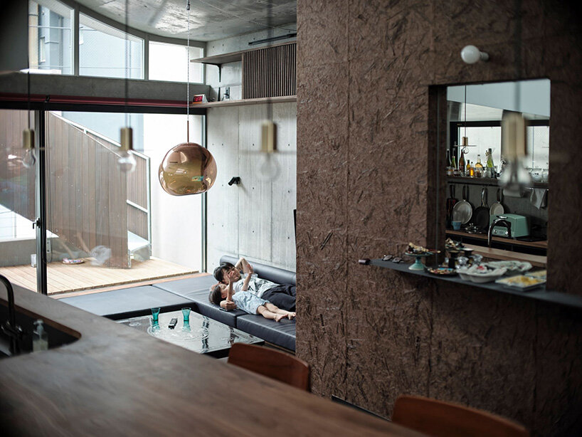 semi-cylindrical roof brings daylight into AOIM's three-story residence in tokyo