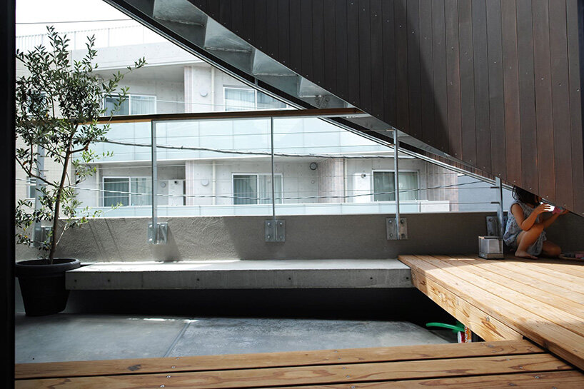 semi-cylindrical roof brings daylight into AOIM's three-story residence in tokyo