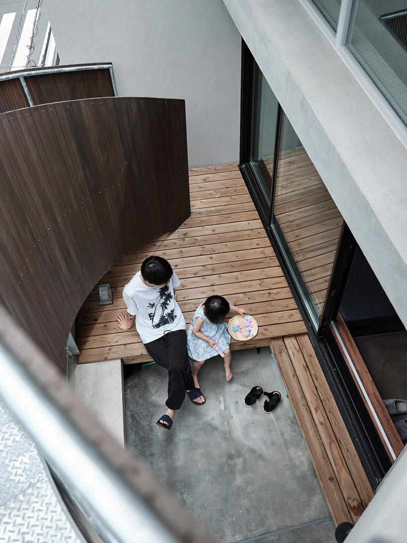 semi-cylindrical roof brings daylight into AOIM's three-story residence in tokyo