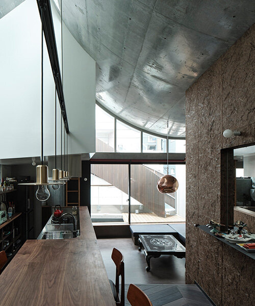 semi-cylindrical roof brings daylight into AOIM's three-story residence in tokyo