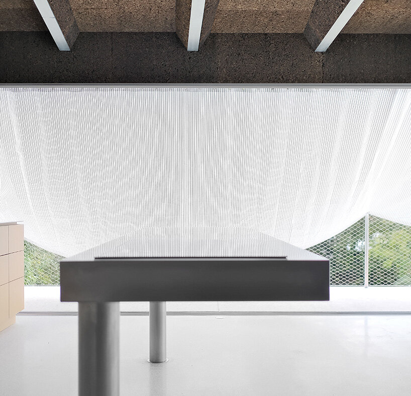 sliding curtains veil ecological cork-clad residence by mesure studio in brittany, france