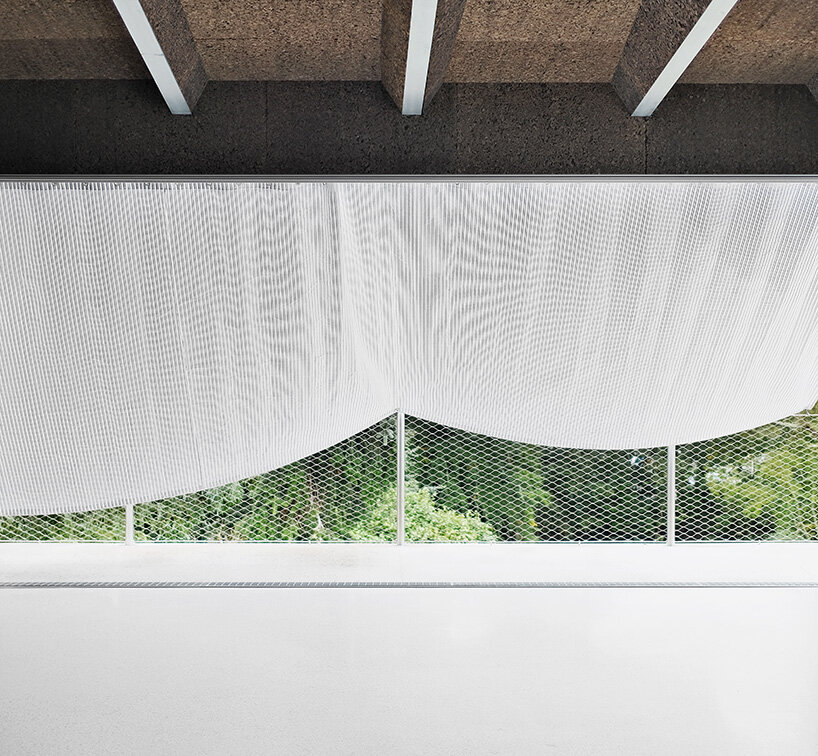 sliding curtains veil ecological cork-clad residence by mesure studio in brittany, france