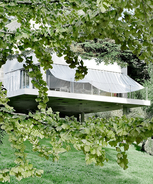 sliding curtains veil ecological cork-clad residence by mesure studio in brittany, france
