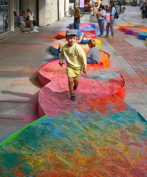 tons of colored aggregates mix together to form color path public art installation in poland