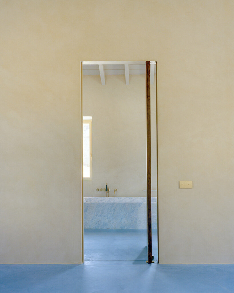 arquitectura-G embeds blue concrete core with spiraling staircase in portuguese residence