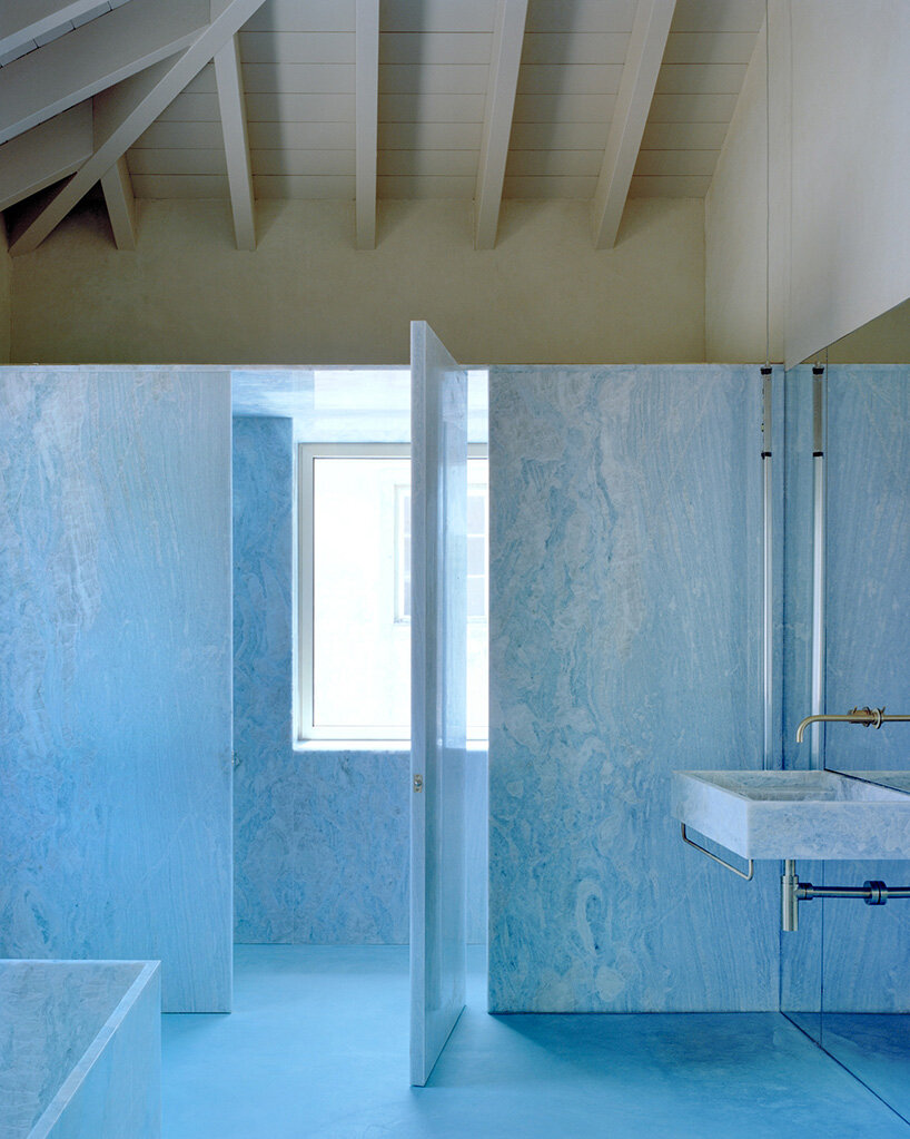 arquitectura-G embeds blue concrete core with spiraling staircase in portuguese residence