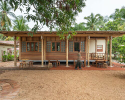 bamboo-clad ice cream shop tucks within coconut grove in thailand