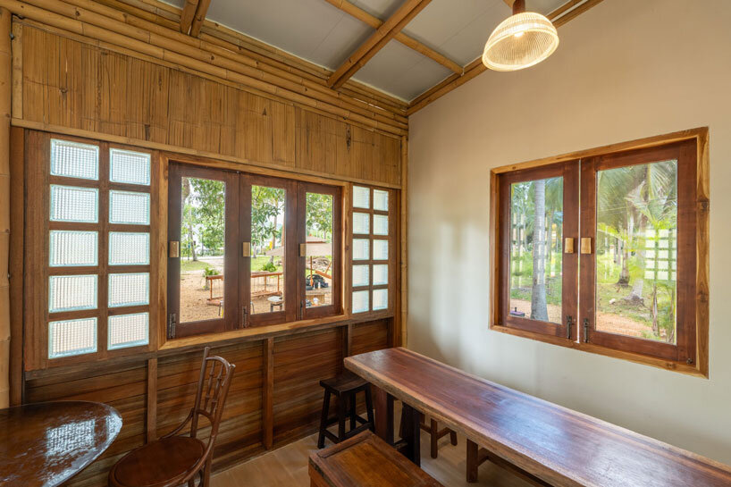bamboo-clad ice cream shop tucks within coconut grove in thailand