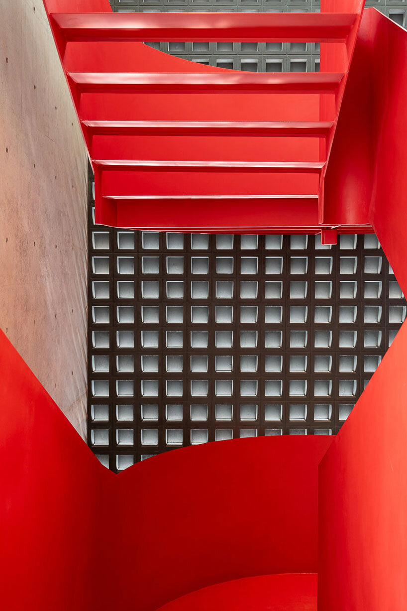 green courtyard anchors hybrid home and office within concrete structure in bangkok