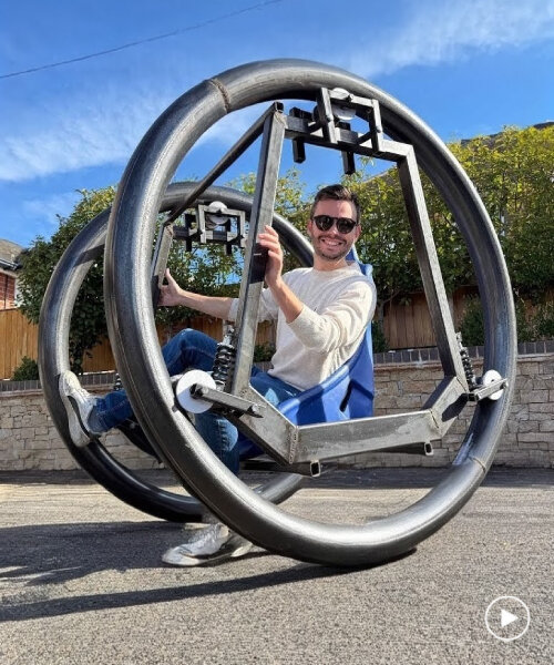 bike with large moving rings and bucket seat rolls the user around without pedaling