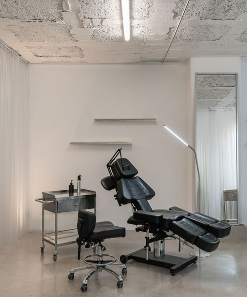 blok tattoo studio in barcelona redefines sterile spaces through concrete and steel interiors