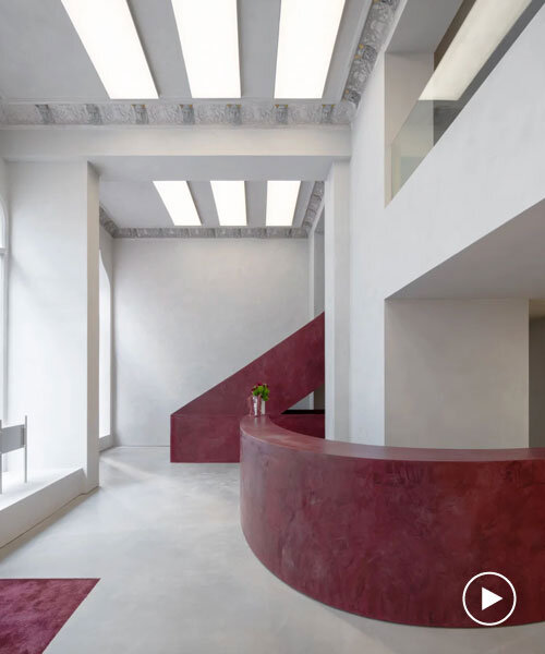 parabolic structures painted in burgundy stucco outline stockholm flagship for chimi eyewear