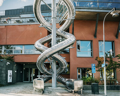 carsten höller's 'stockholm slides' spiral down the waterfront face of moderna museet