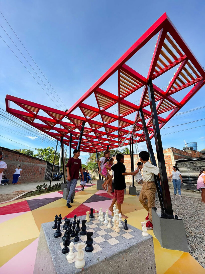 recycled materials transform abandoned triangular lot in colombia into colorful urban space