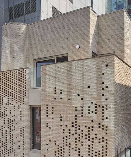 perforated brickwork forms pixelated pattern upon restored seoul building by NOMAL