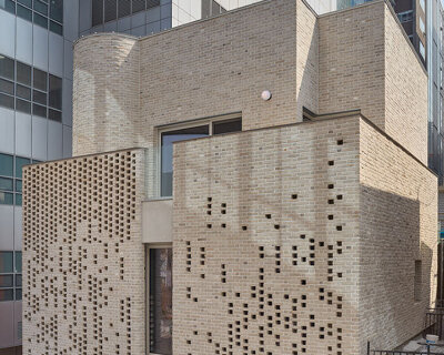 perforated brickwork forms pixelated pattern upon restored seoul building by NOMAL