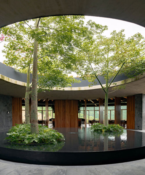 curved stone pavilion encloses circular reflecting pool for clubhouse in mexico