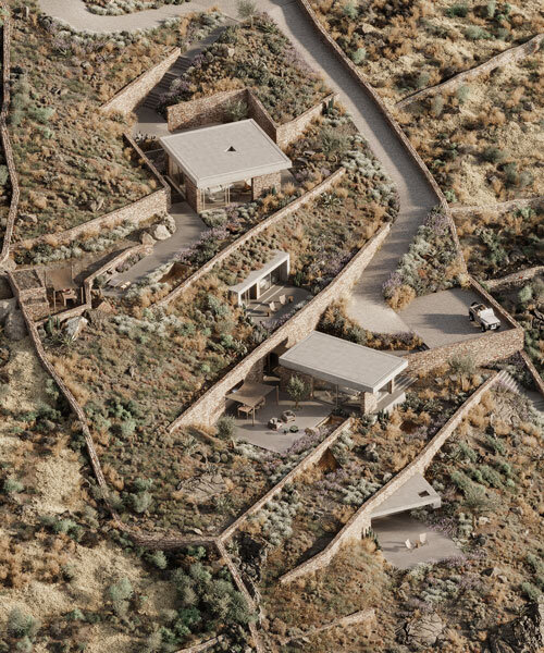 kapsimalis architects embeds stone-clad cave homes into greek island's hillside