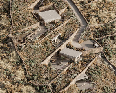 kapsimalis architects embeds stone-clad cave homes into greek island's hillside