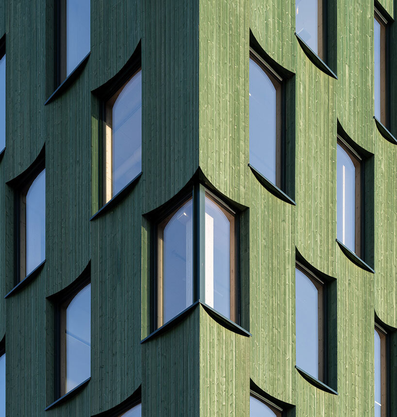 green timber curves sculpt rhythmic facade for office building in norway
