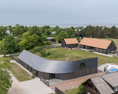 MADE arhitekti's twisting pāvilosta house seems to be carved by latvia's coastal winds