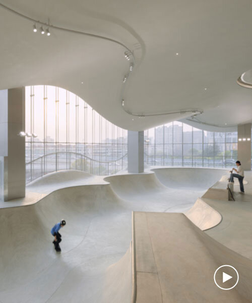 curved urban skatepark set within floating glass volume overlooks shanghai’s skyline