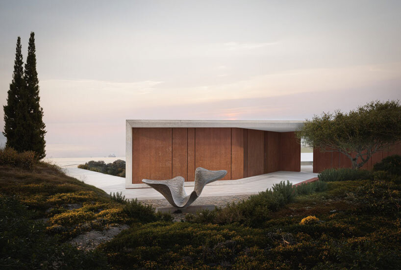 summer residence's sharp geometry emerges from greek seaside slope