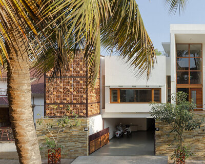 perforated terracotta screens enclose pool pavilion within indian residence