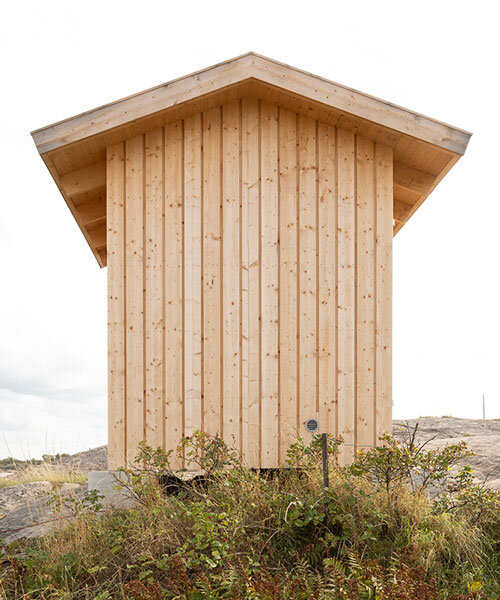 untreated wooden cladding wraps vernacular sauna sövall on sweden's rocky shoreline