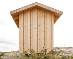 untreated wooden cladding wraps vernacular sauna sövall on sweden's rocky shoreline