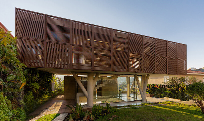 TETRO elevates house on concrete tree-like columns above the hills of belo horizonte, brazil