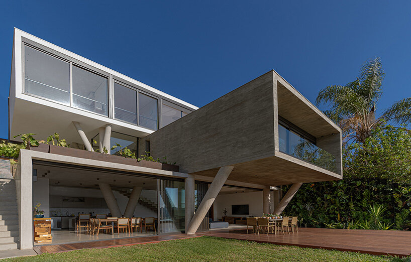 TETRO elevates house on concrete tree-like columns above the hills of belo horizonte, brazil