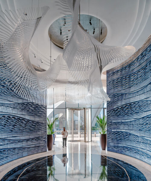 two 3D printed ceramic walls by studio RAP rise like sculpted waves at dubai hotel's entrance