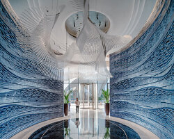 two 3D printed ceramic walls by studio RAP rise like sculpted waves at dubai hotel's entrance