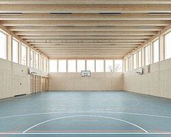 vertical timber construction shapes twin stacked sports halls in switzerland by kit