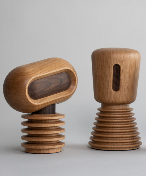 mini sculptural robots for homes are crafted entirely from danish oak wood