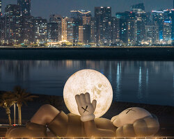 32-meter companion by KAWS lifts glowing moon along abu dhabi's waterfront