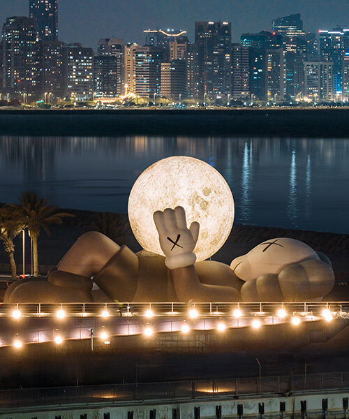 32-meter companion by KAWS lifts glowing moon along abu dhabi's waterfront