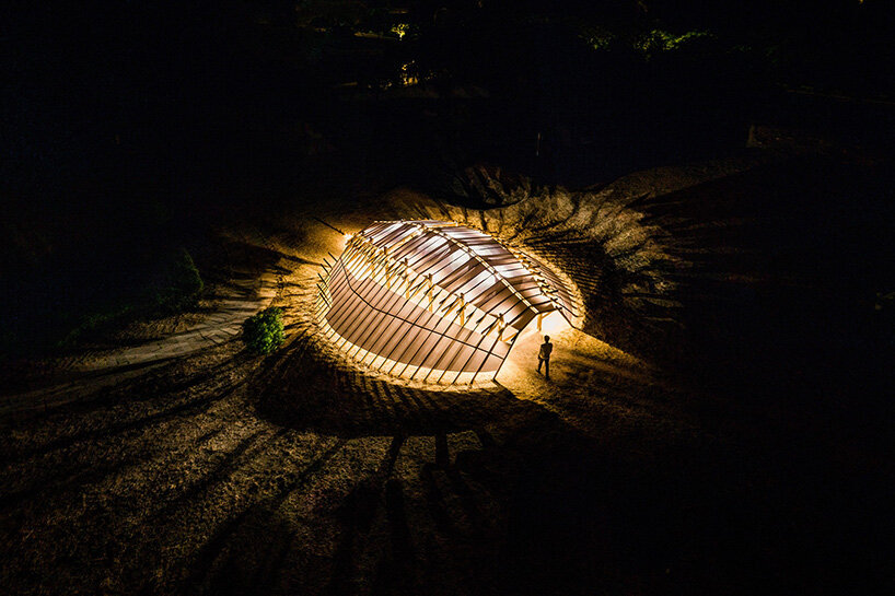 arching timber shell installation by cheng tsung feng evokes the horseshoe crab in taiwan