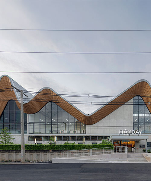 three asymmetrical curved gable roofs top ASWA’s community hub in thailand