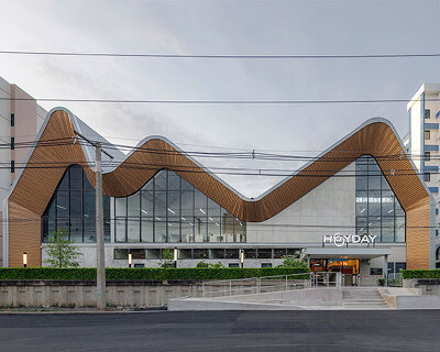 three asymmetrical curved gable roofs top ASWA’s community hub in thailand